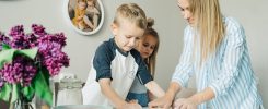Mother and children enjoying a fun and messy baking session together at home.
